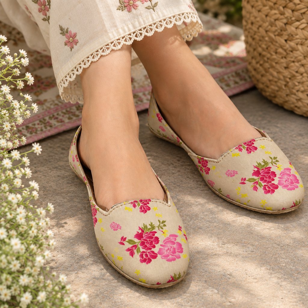 A woman wearing beige slip-on flats with a pink and yellow floral printed ladies khussa in karachi.