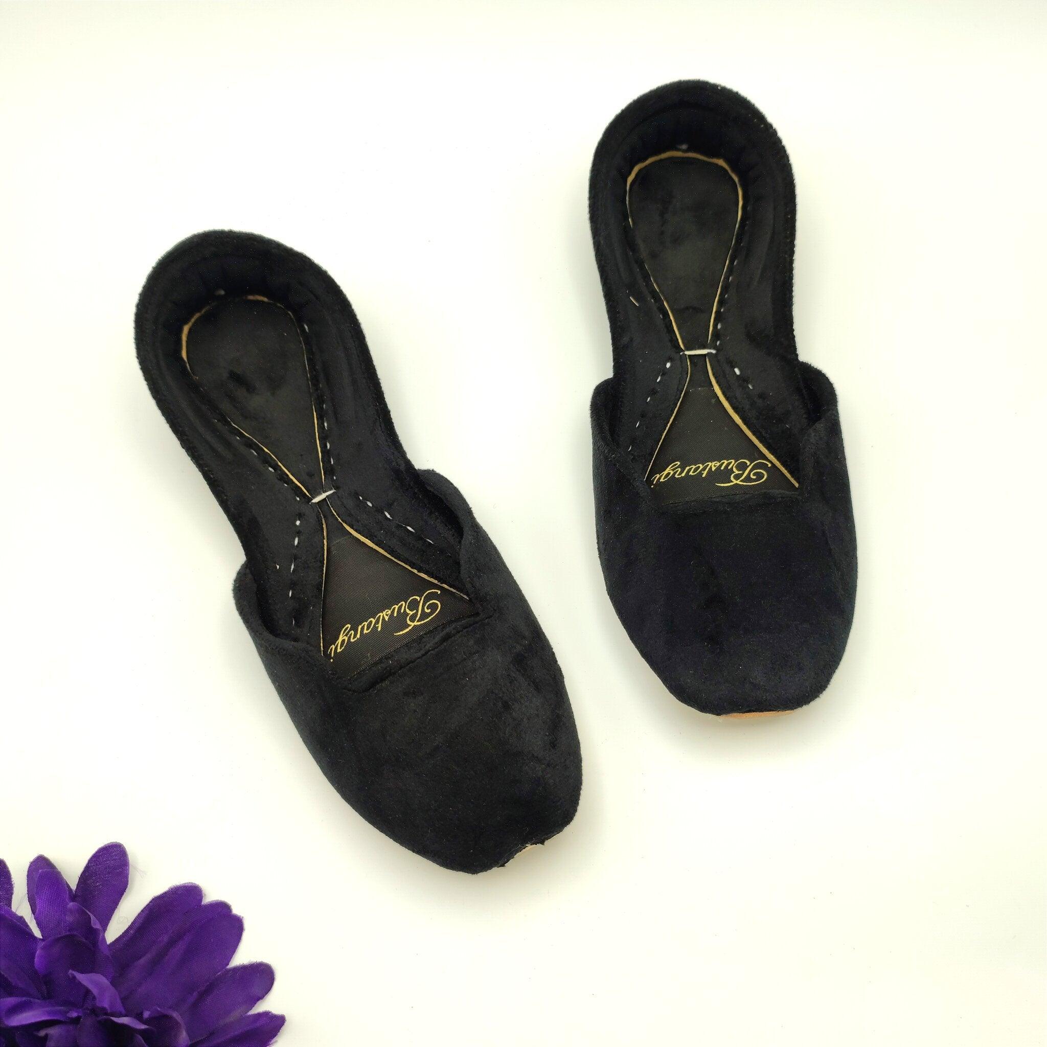 Black Khussa with gold logo on a white background
